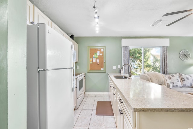 kitchen featuring ceiling fan, light tile patterned floors, sink, white appliances, and light stone countertops