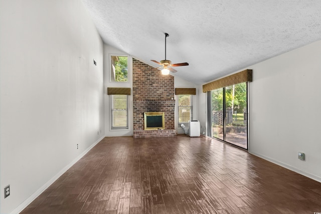unfurnished living room featuring a brick fireplace, a ceiling fan, a textured ceiling, and wood finished floors