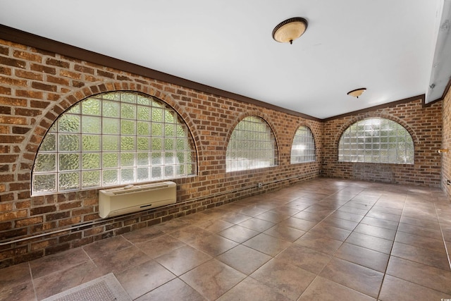 interior space with brick wall and a healthy amount of sunlight