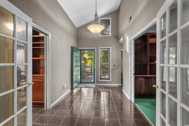 doorway with high vaulted ceiling, french doors, baseboards, dark tile patterned floors, and visible vents