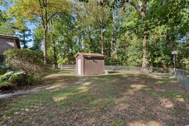 view of yard with a storage shed, an outdoor structure, and a fenced backyard
