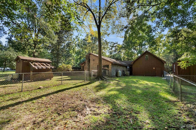 view of yard with a fenced backyard and an outbuilding