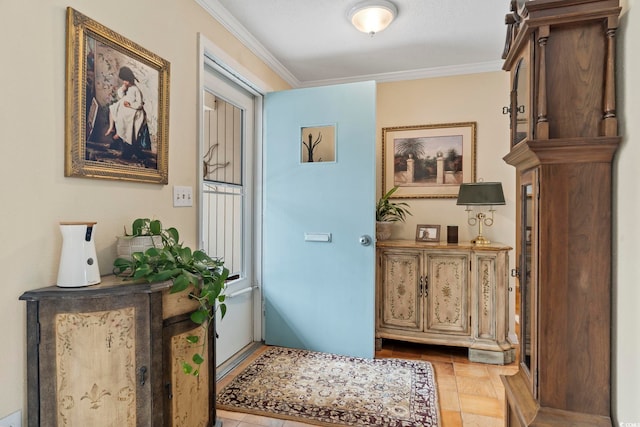 tiled entryway with ornamental molding and a textured ceiling