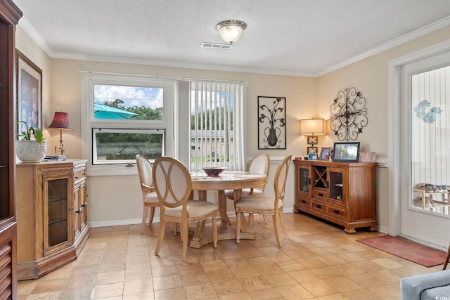 dining area with crown molding and a textured ceiling