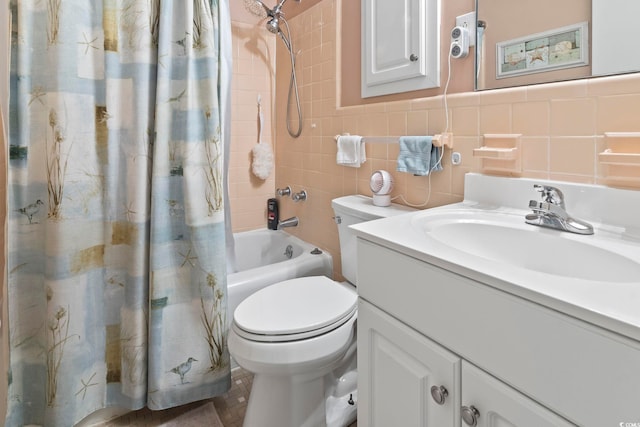 full bathroom with vanity, toilet, shower / bath combo with shower curtain, and tile walls