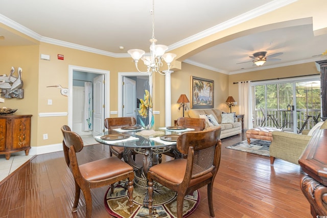 dining area with ceiling fan with notable chandelier, wood-type flooring, and ornamental molding