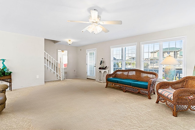 sitting room featuring light carpet and ceiling fan