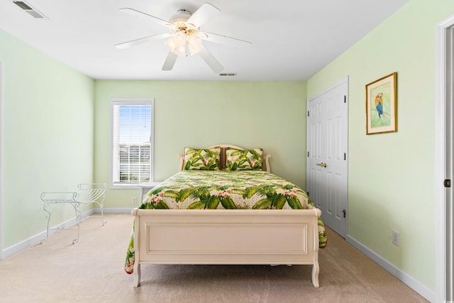 bedroom featuring light carpet and ceiling fan