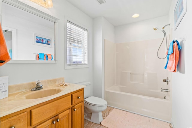 full bathroom featuring vanity, toilet, wood-type flooring, and  shower combination