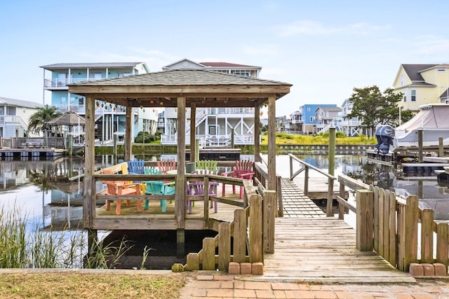 view of dock with a water view and a gazebo