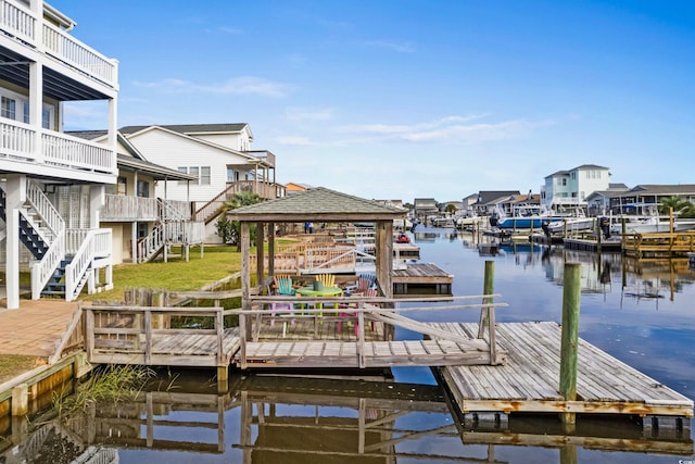 view of dock with a deck with water view and a gazebo