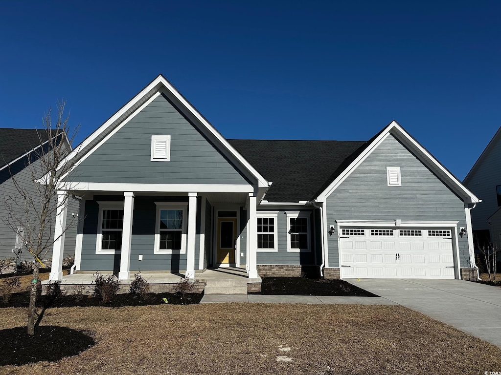 view of front of property with a front yard and a garage