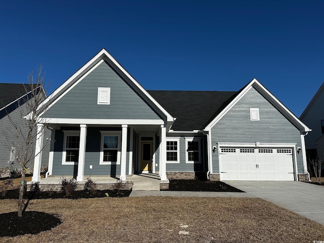 view of front of property with a front yard and a garage