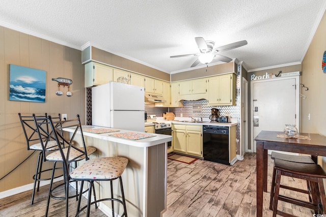 kitchen with black dishwasher, a breakfast bar, light wood-type flooring, electric stove, and white refrigerator