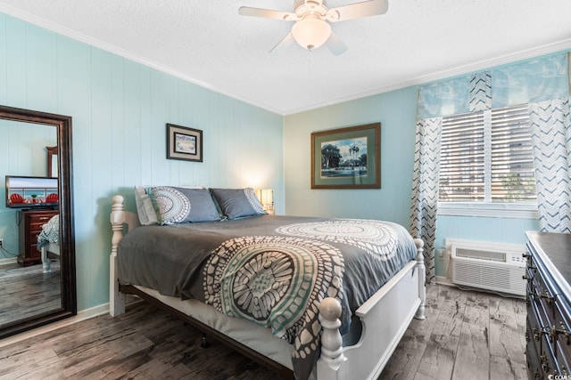 bedroom featuring hardwood / wood-style flooring, an AC wall unit, crown molding, ceiling fan, and wood walls