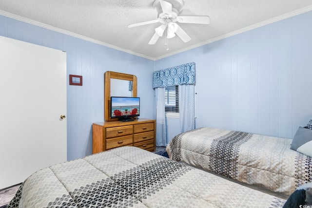 bedroom with ceiling fan, ornamental molding, a textured ceiling, and wooden walls