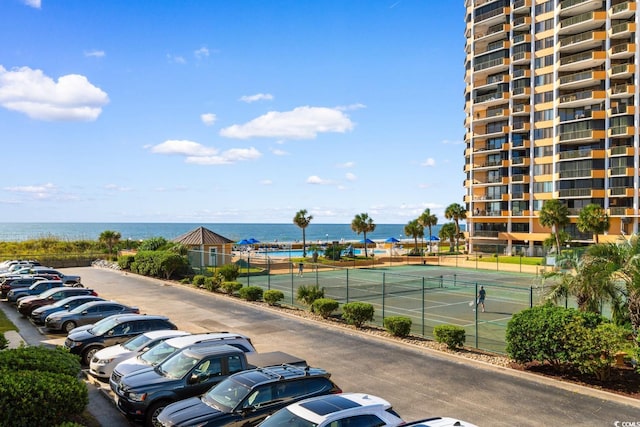 exterior space featuring a water view and tennis court