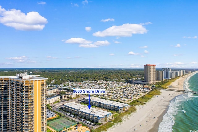 bird's eye view with a water view and a beach view