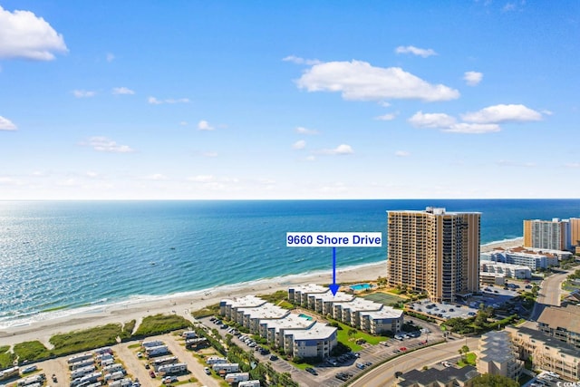 bird's eye view featuring a water view and a view of the beach