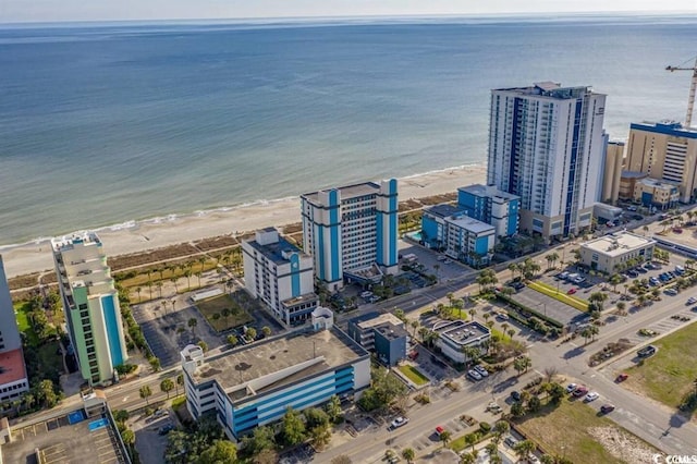 birds eye view of property featuring a beach view and a water view