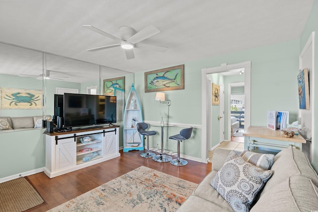 living room with hardwood / wood-style flooring and ceiling fan