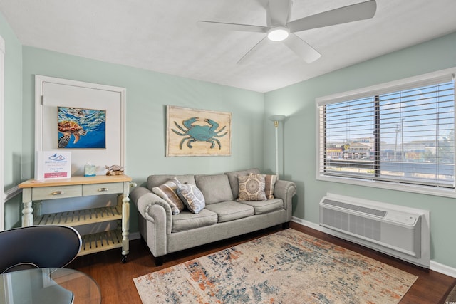 living room with dark wood-type flooring, ceiling fan, and a wall mounted air conditioner