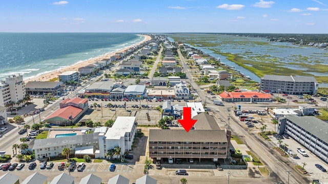 bird's eye view with a water view and a beach view