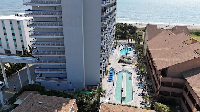 birds eye view of property with a beach view and a water view