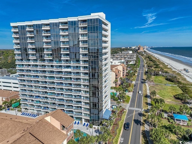 view of property featuring a water view and a beach view