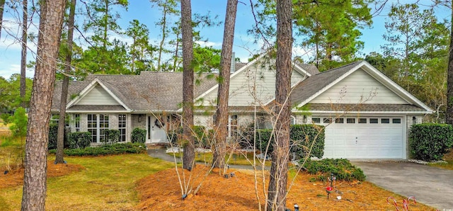 view of front of house featuring a garage and a front lawn