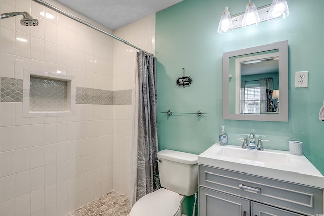 bathroom with a shower with shower curtain, vanity, and toilet