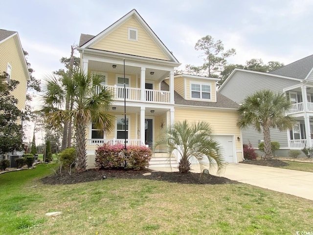 view of front facade with a garage, a front yard, a balcony, and a porch