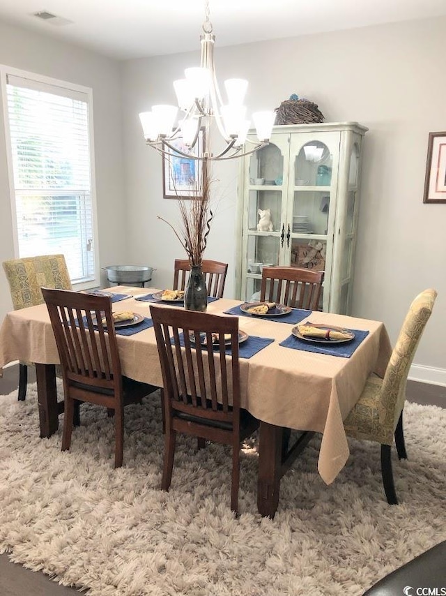 dining area with an inviting chandelier