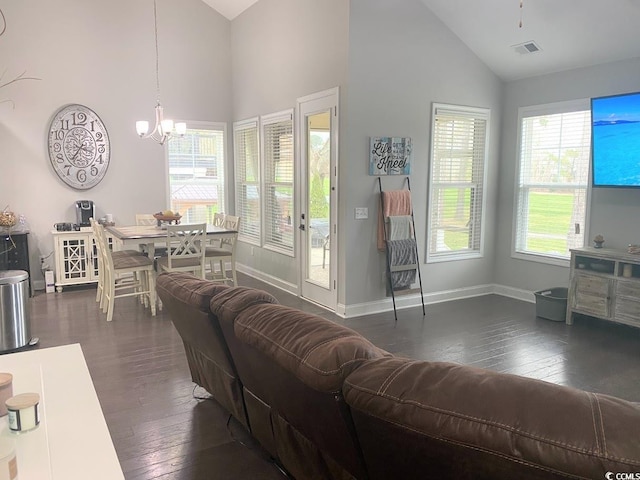 living room with a notable chandelier, high vaulted ceiling, and dark hardwood / wood-style floors