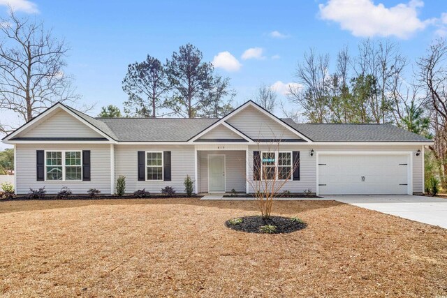 view of front facade with a front lawn and a garage