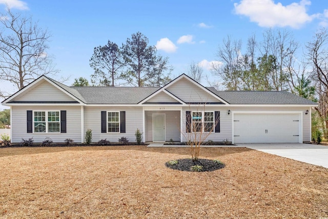 ranch-style house featuring a garage, a shingled roof, a front lawn, and concrete driveway