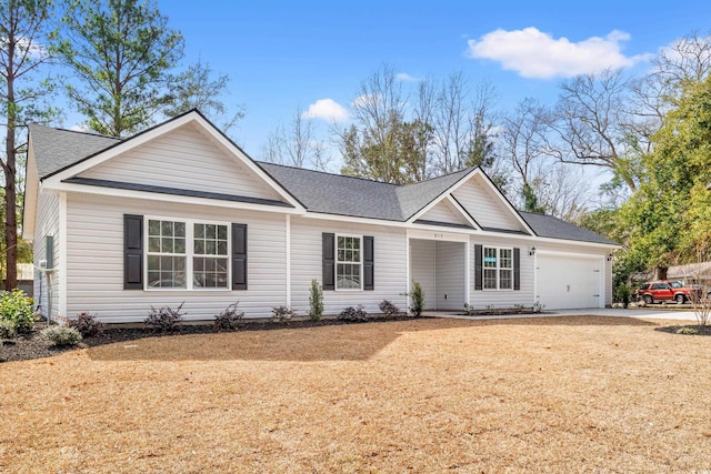 ranch-style home with an attached garage, driveway, a front lawn, and a shingled roof