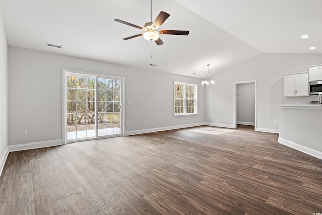 unfurnished living room featuring dark wood-style floors, visible vents, vaulted ceiling, baseboards, and ceiling fan with notable chandelier