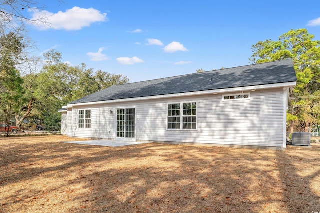 rear view of house with central air condition unit, a yard, and a patio