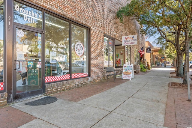 view of exterior entry featuring brick siding