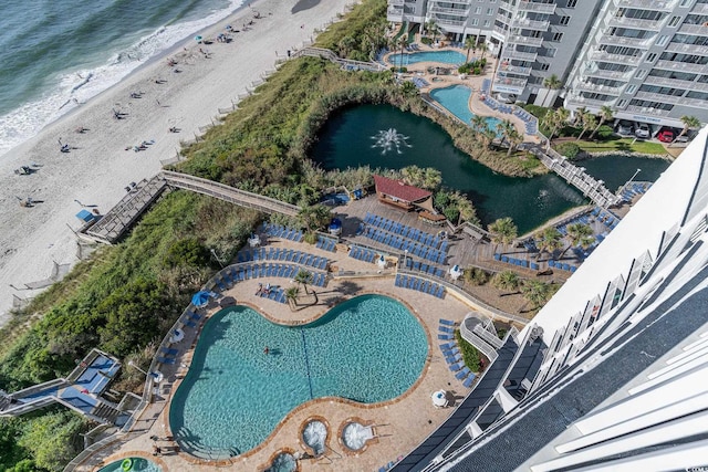 bird's eye view featuring a beach view and a water view