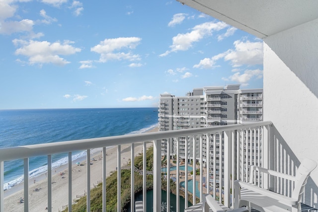 balcony with a water view and a beach view