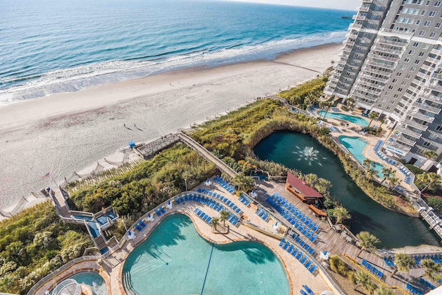 bird's eye view featuring a water view and a view of the beach