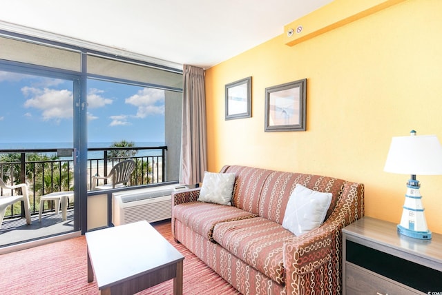 living room with floor to ceiling windows, plenty of natural light, a water view, and a wall mounted air conditioner