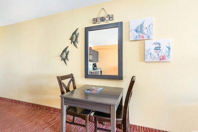 dining space featuring carpet