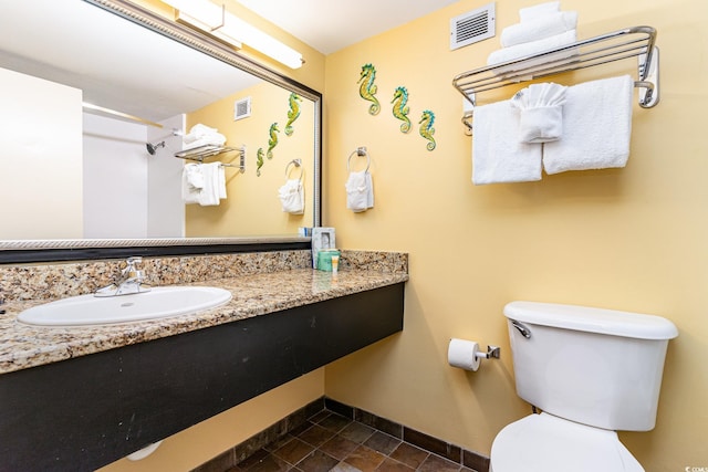 bathroom with vanity and toilet