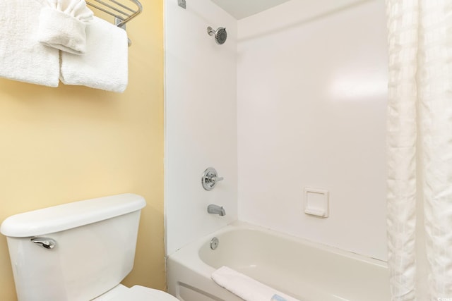 bathroom featuring shower / bath combination with curtain and toilet