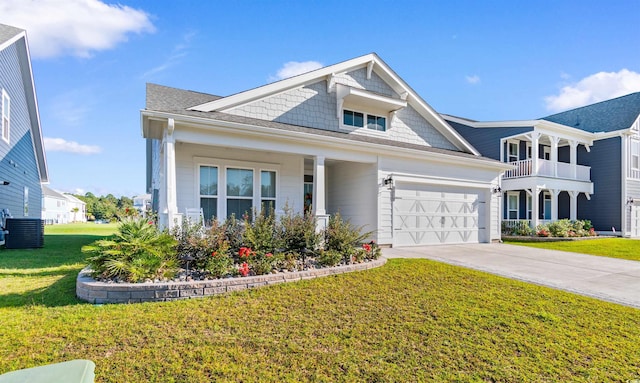 view of front of property with a balcony, a garage, central AC unit, and a front yard