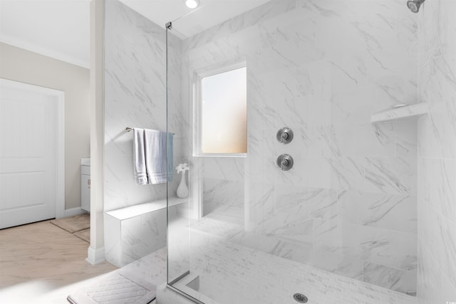 bathroom with a tile shower and vanity