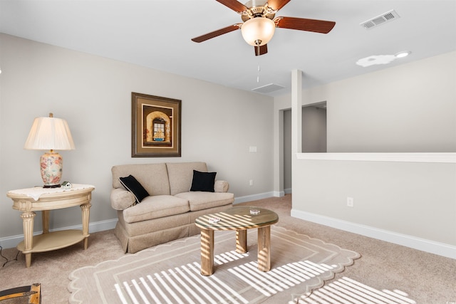 living room with ceiling fan and light colored carpet